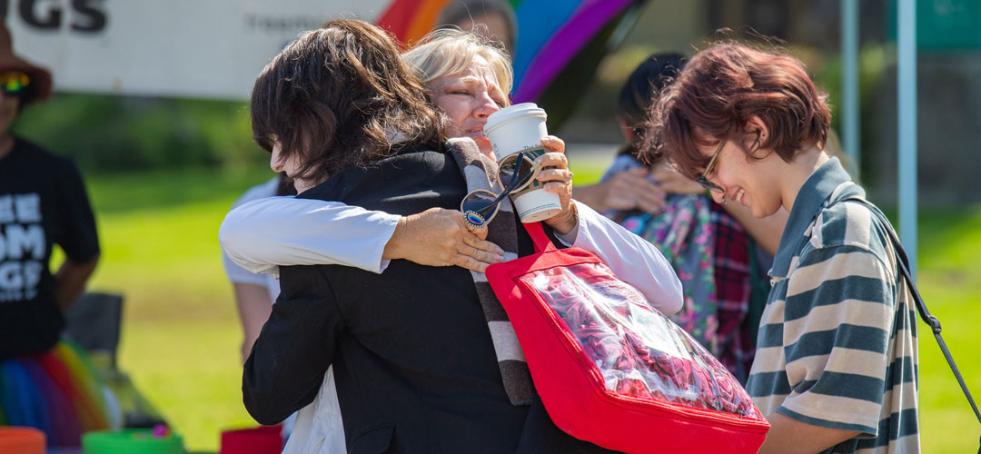 Giving hugs to students